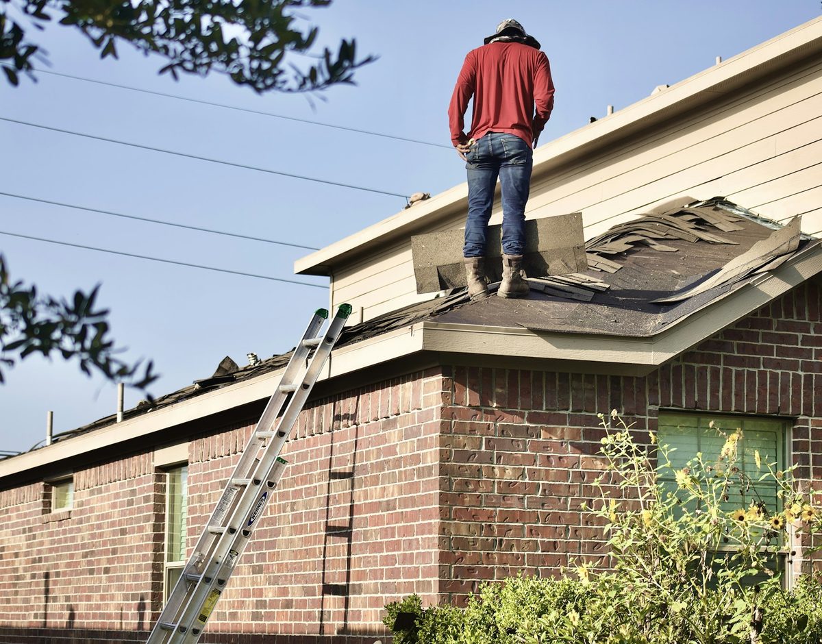 Roofing contractor working on a residential roof
